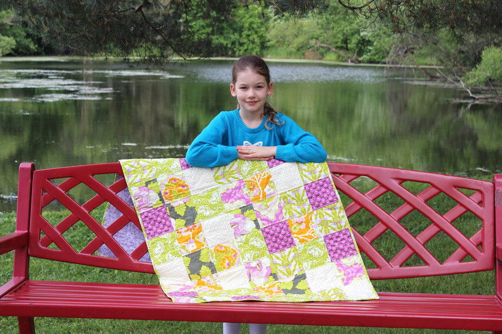 Gwyneth and her first quilt